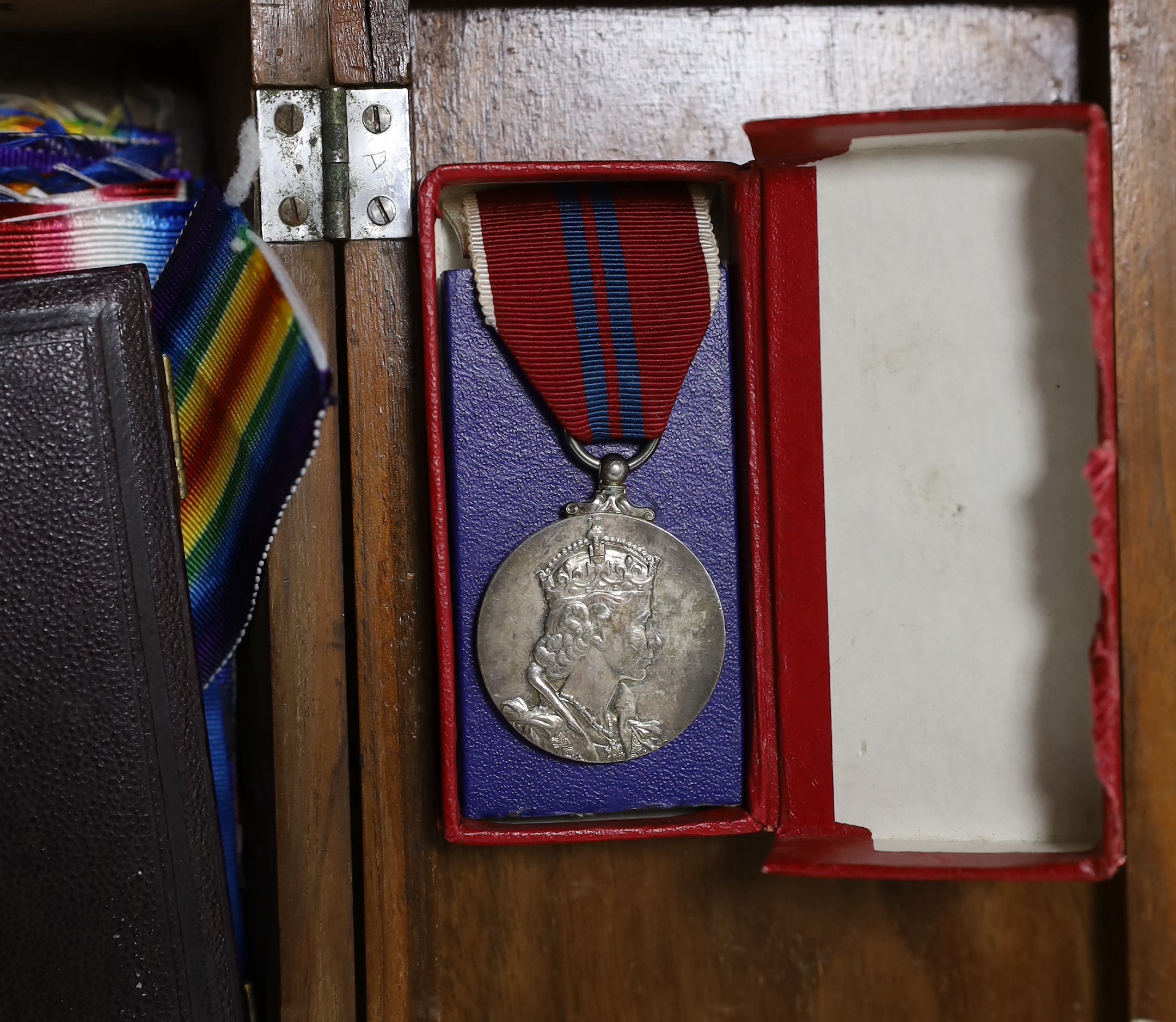 A collection of mainly British medals, awards and associated items including; six coronation medals for ERII, GRVI and GRV, three Victory Medals and a 1914-15 Star, a good selection of WWI and later miniatures including